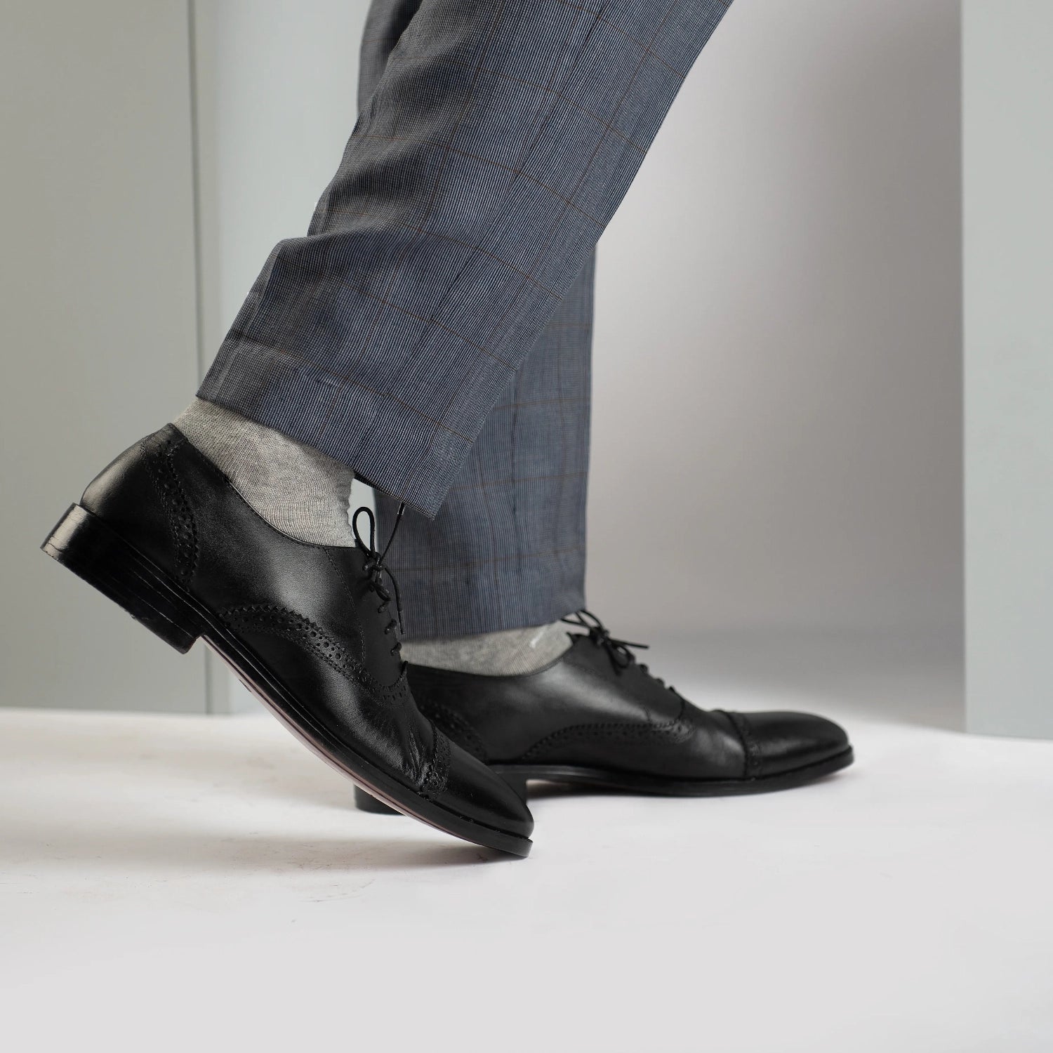 Black dress shoes with grey pants top